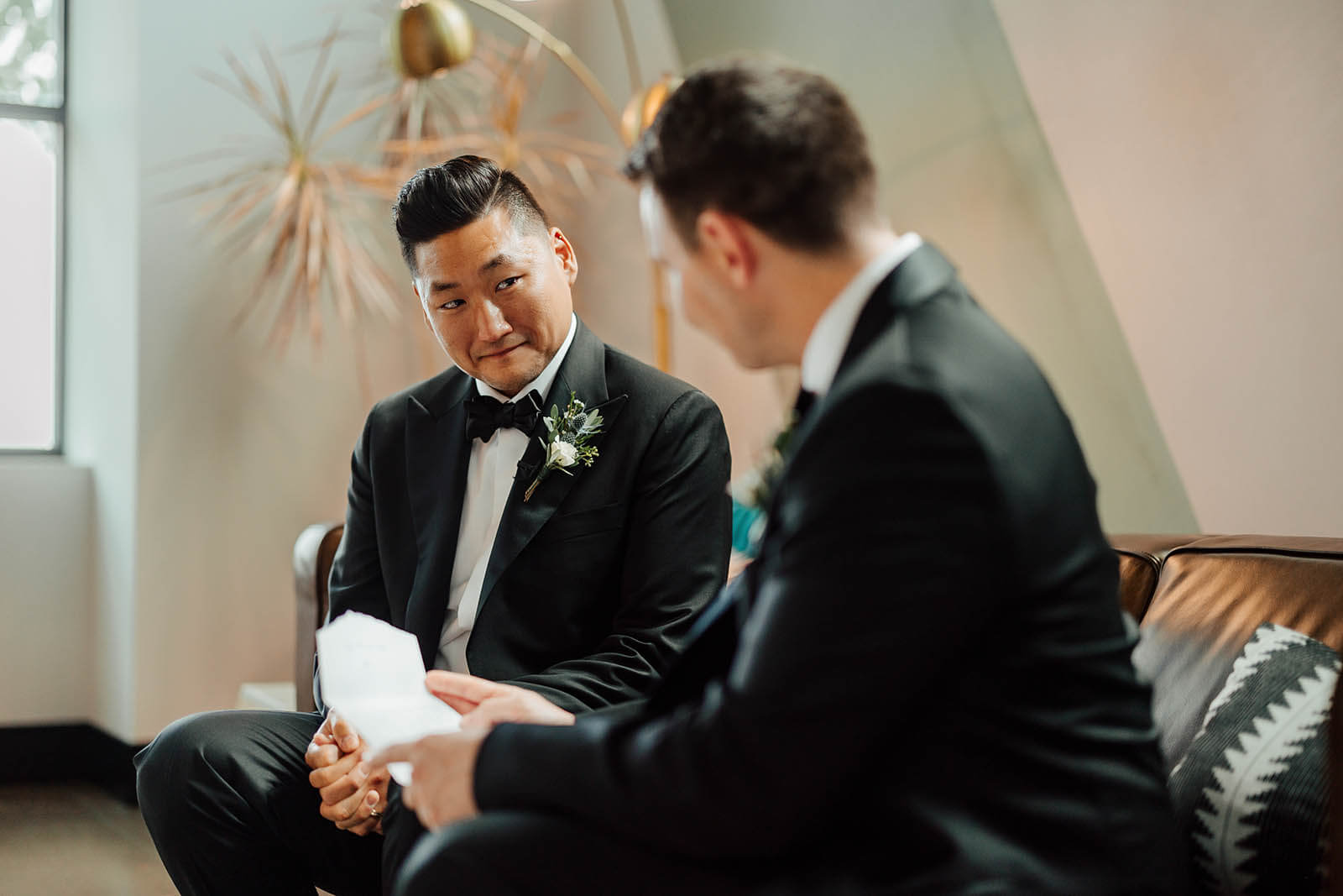 GAUPERphoto West Michigan wedding photographer candid groom emotional reading letter from bride while groomsman listens, best documentary wedding photography Grand Rapids