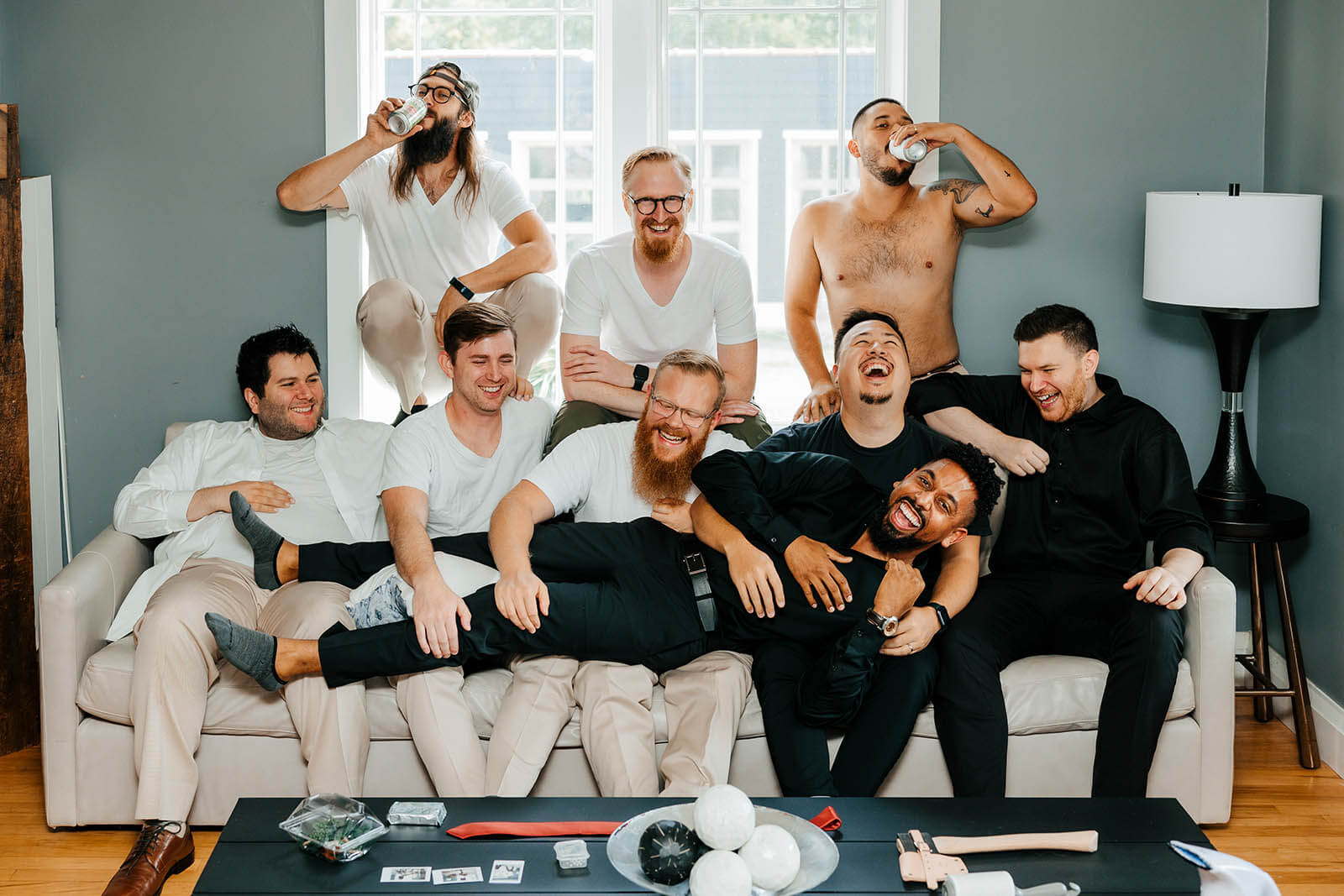 Tabor Hill Winery wedding photographer St Joseph Michigan candid groomsmen laughing together on couch during getting ready, top Southwest Michigan documentary wedding photography