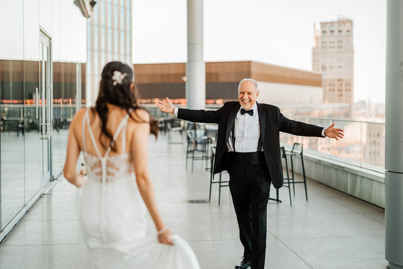 Elevate One Campus Martius wedding photographer downtown Detroit candid father of bride arms wide open overjoyed at first look on rooftop, top luxury Detroit Michigan wedding photography GAUPERphoto