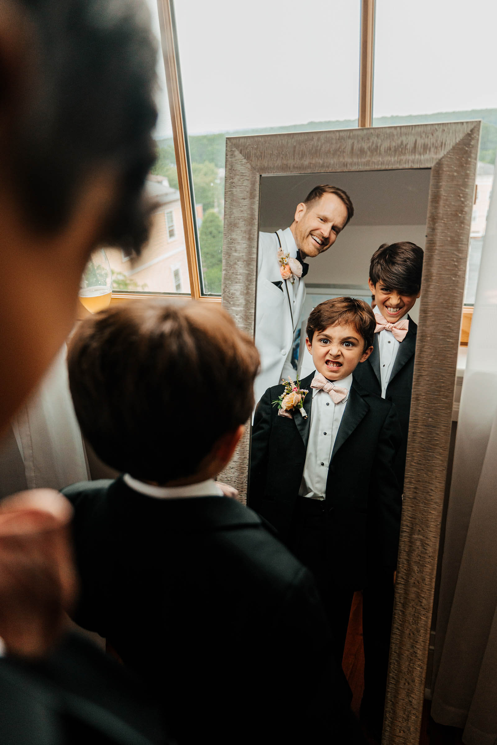 GAUPERphoto Rhode Island wedding photographer Varnums House East Greenwich candid ring bearer in tuxedo making faces at mirror with groom and boys getting ready, best destination wedding photography