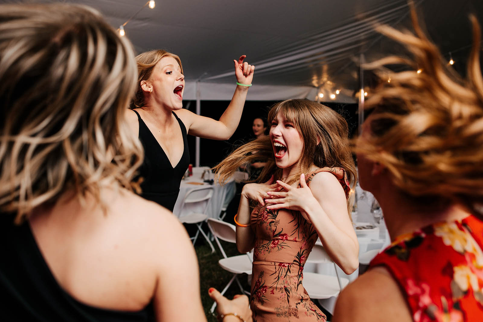 Bay Pointe Inn wedding photographer Shelbyville Michigan candid wedding guests wild on dance floor at outdoor tented reception, top West Michigan documentary wedding photography