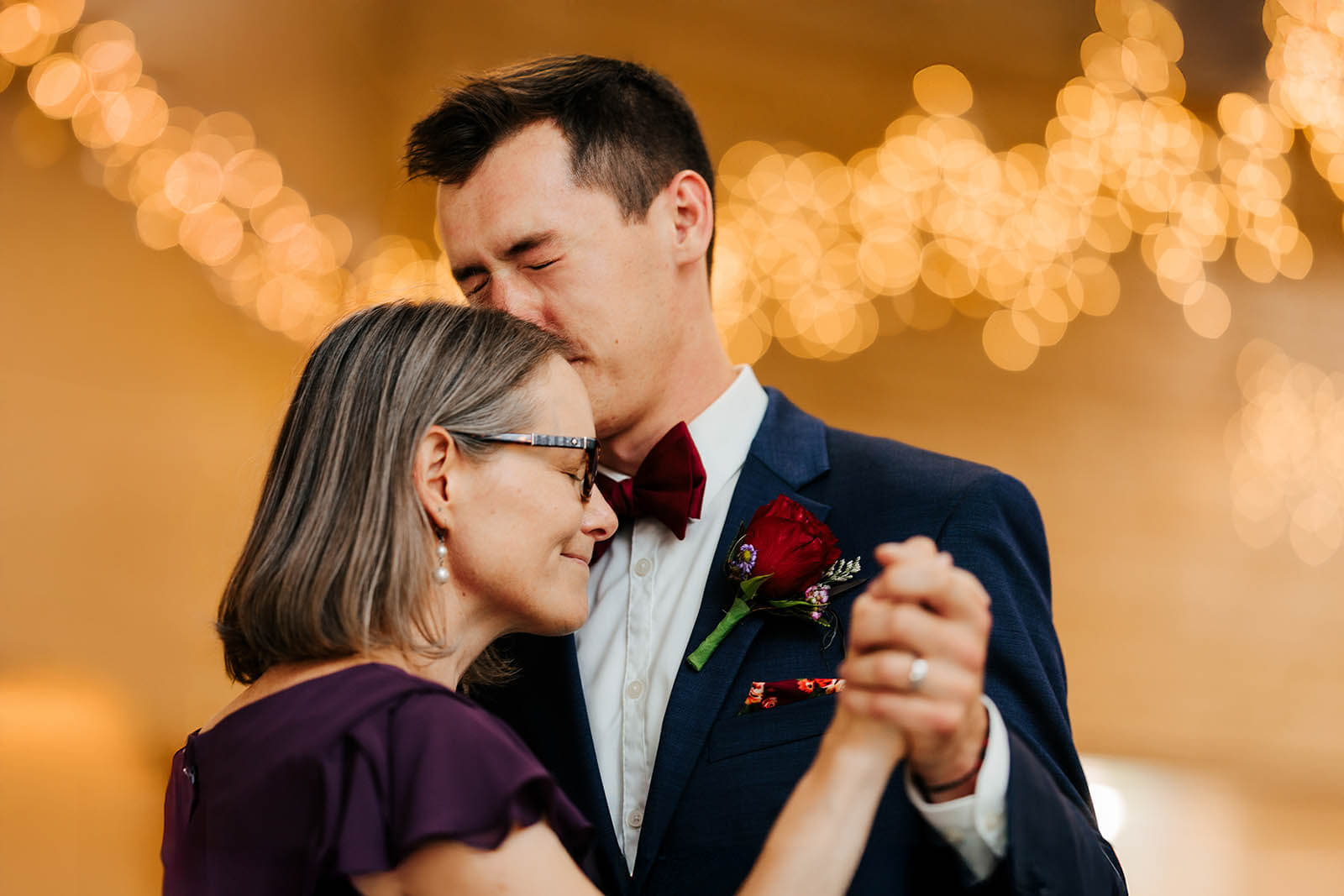 GAUPERphoto The Gathering wedding photographer Coldwater Michigan candid groom kissing mother on forehead during intimate mother son dance, best documentary Michigan wedding photography