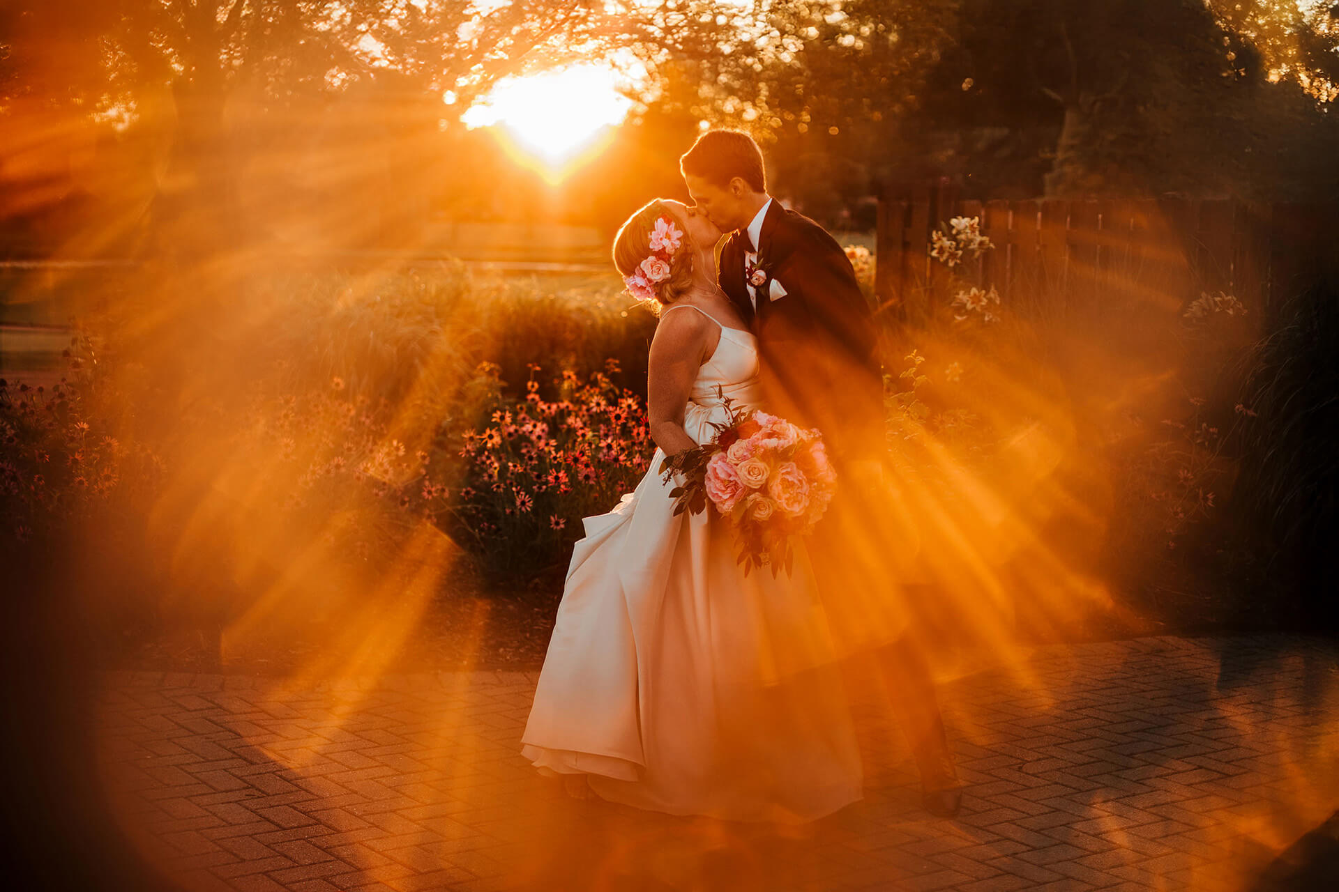 Wedding couple embracing in golden light