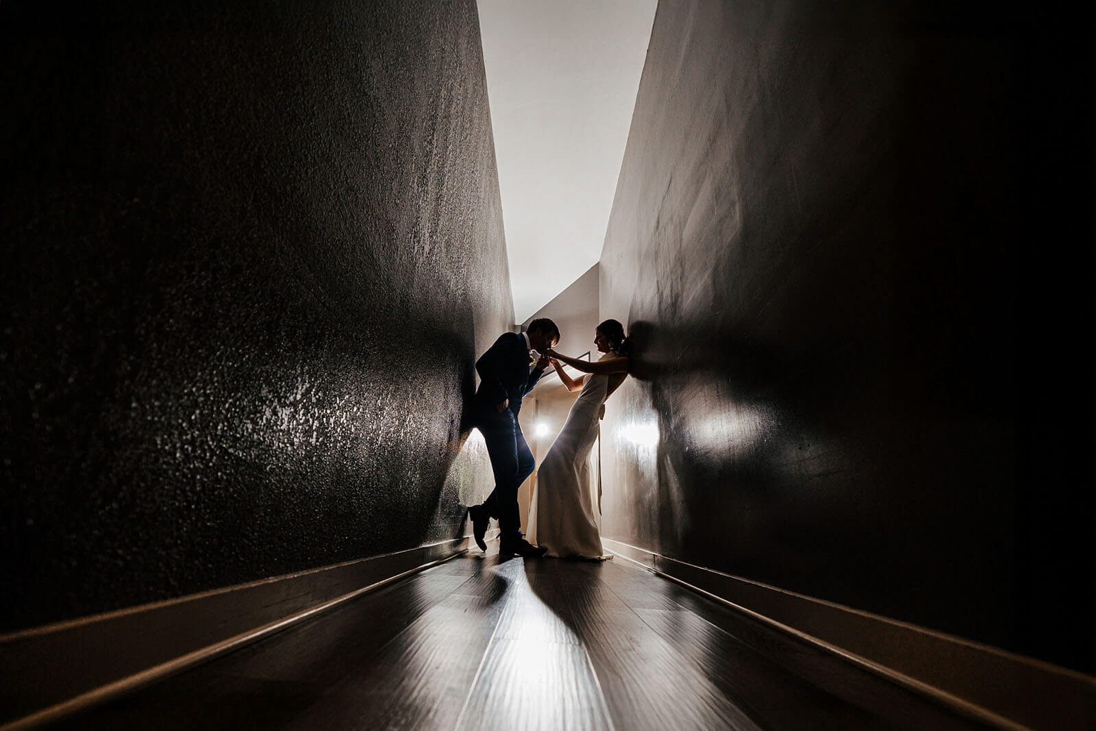 Editorial bride and groom portrait in dark narrow corridor at South Haven Creations wedding in Michigan