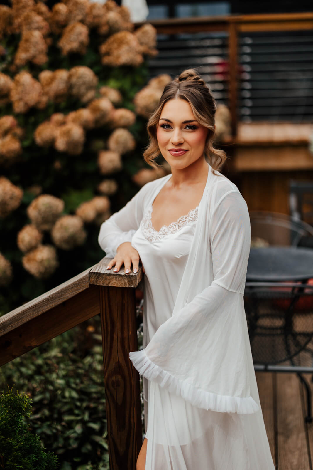 Bride portrait in white robe with hydrangeas at Westers Family Winery Junction Michigan