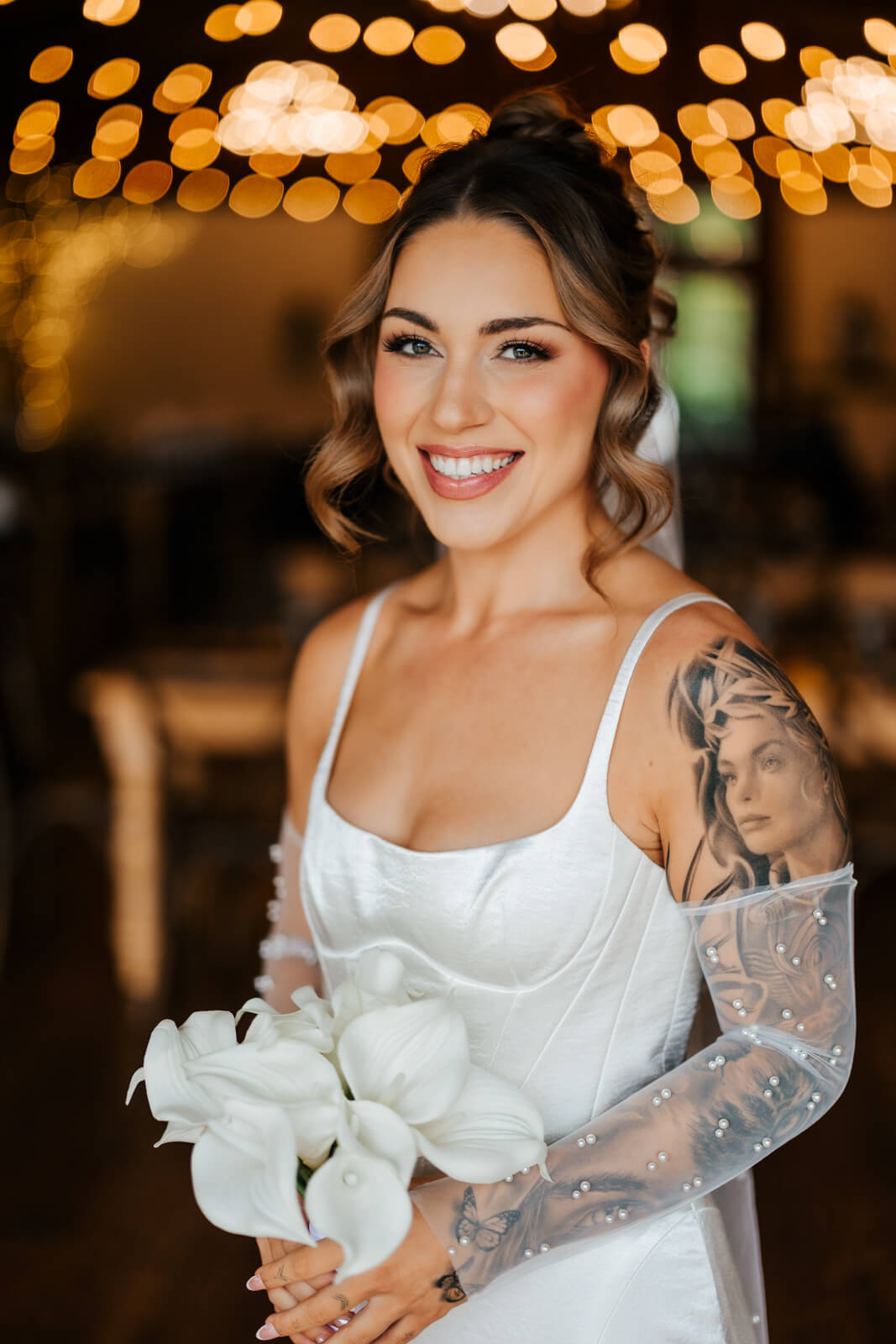 Bride portrait smiling under string lights at Westers Family Winery reception