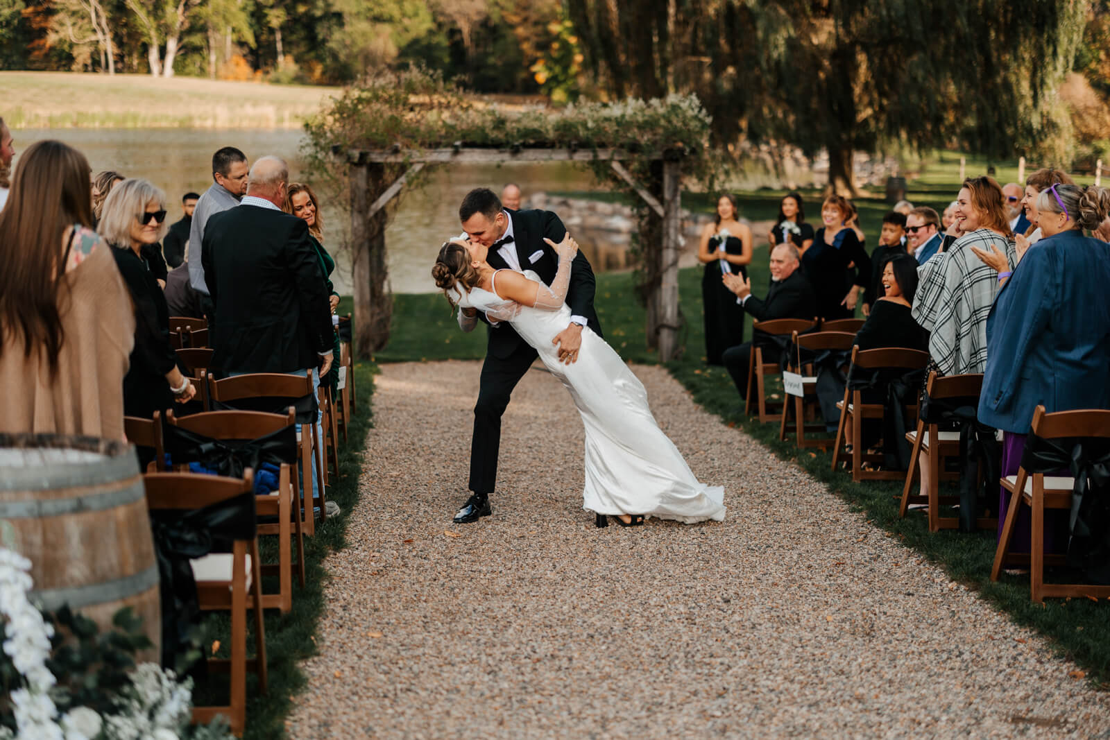 Bride and groom walking back down aisle together as newlyweds at outdoor winery ceremony