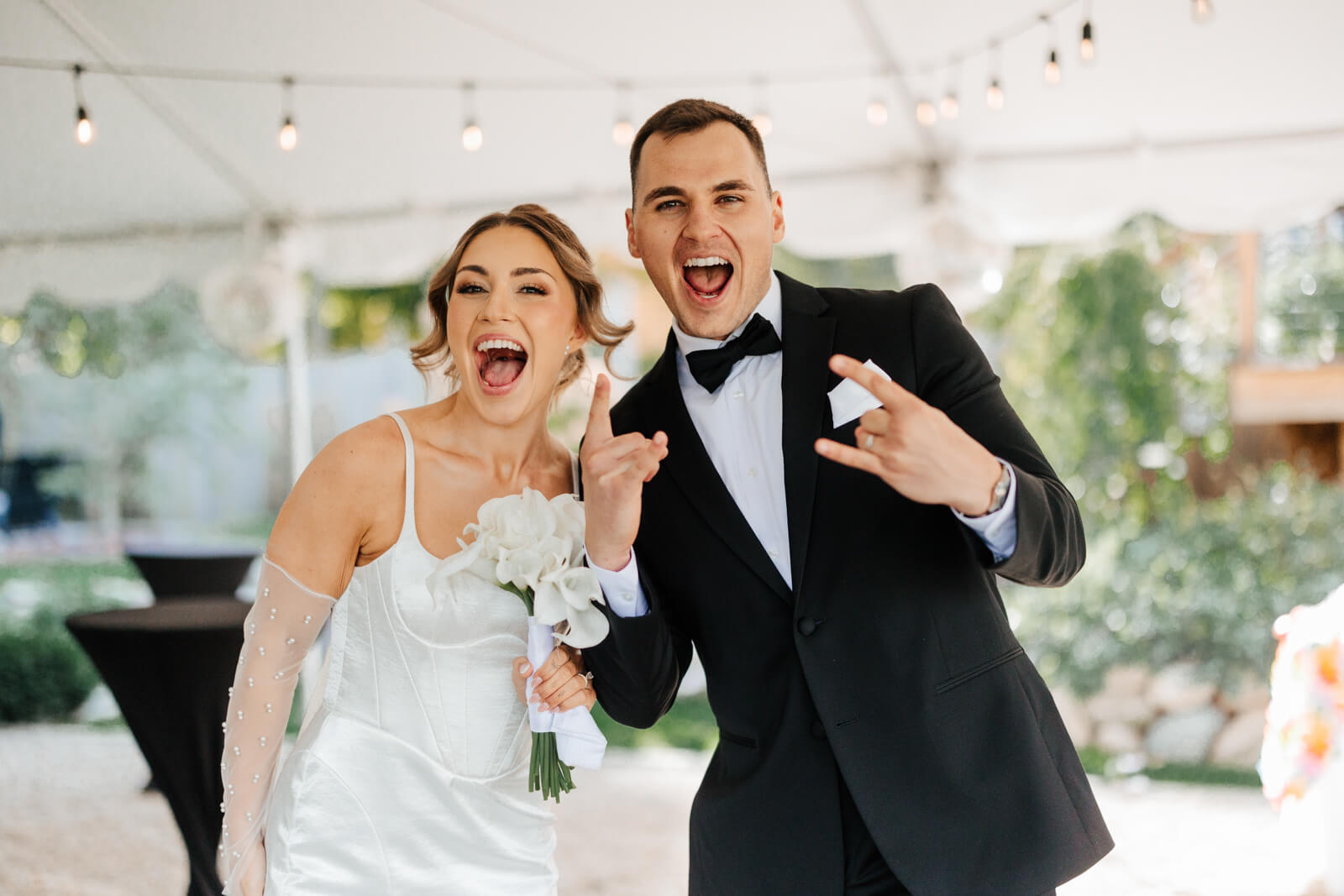 Bride and groom cheering and celebrating just after wedding ceremony at Westers Family Winery