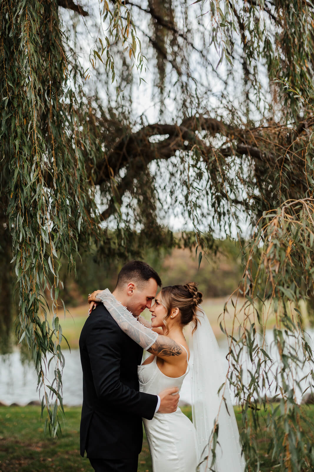 Couple embracing under weeping willow