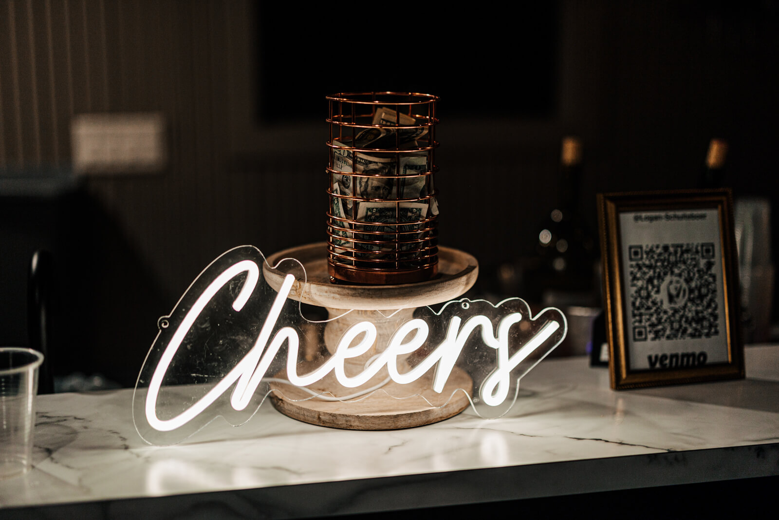 Black wedding cake with Cheers neon sign at Westers Family Winery reception