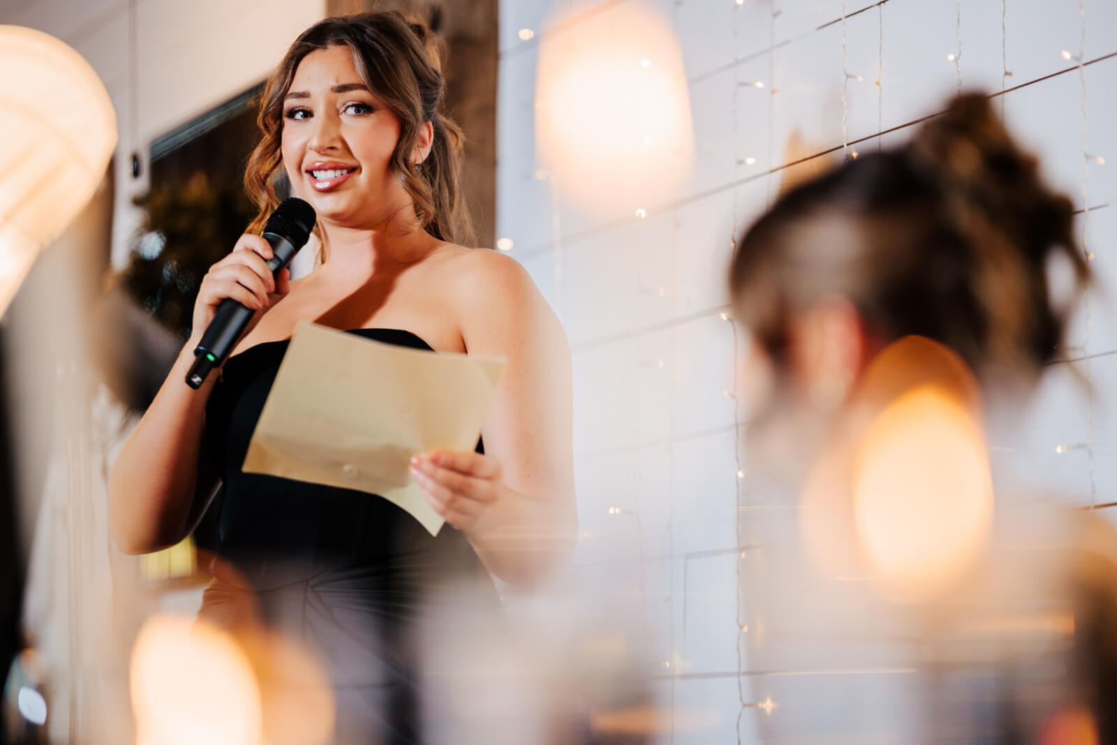 Bridesmaid giving wedding speech with microphone at Westers Family Winery reception