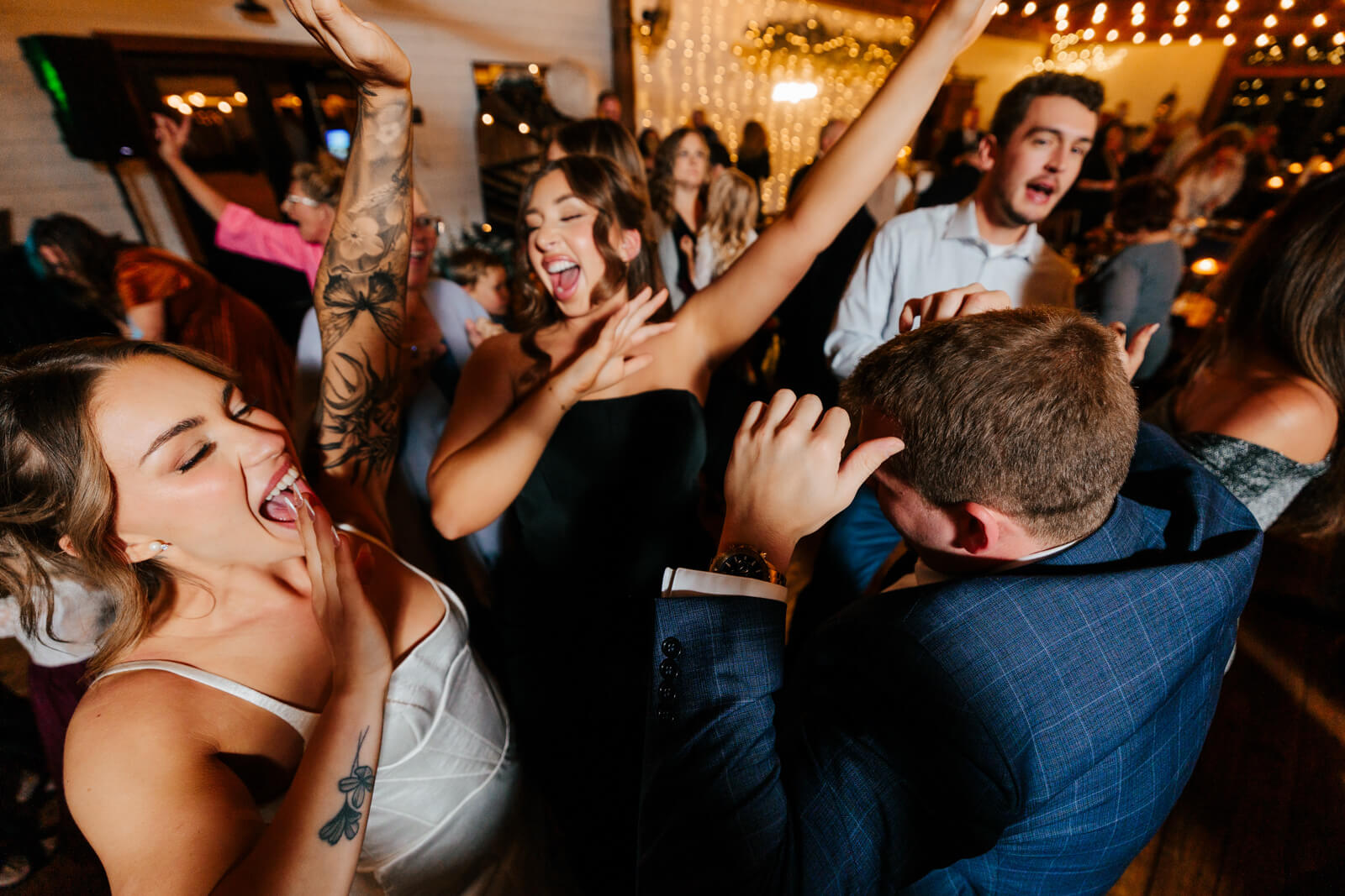 Bride dancing wildly and having a blast in the crowd at Westers Family Winery reception